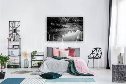 Black-and-white canvas print of a serene lake with tree reflections titled Willow Water Reflections mounted on white wall