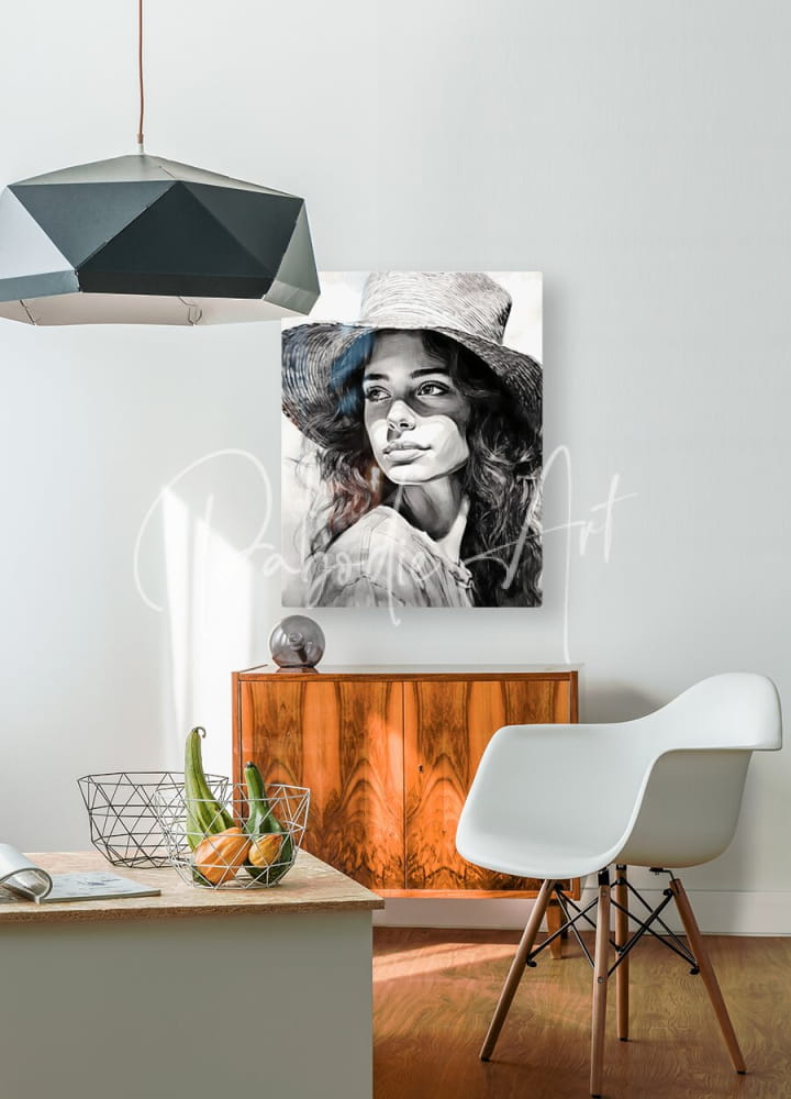 Black-and-white portrait canvas of a woman in a wide-brimmed hat titled a womans casual glance mounted on white wall
