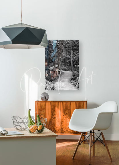 Black and white canvas print of a forest scene with a winding wooden path mounted on the wall titled the wooden path